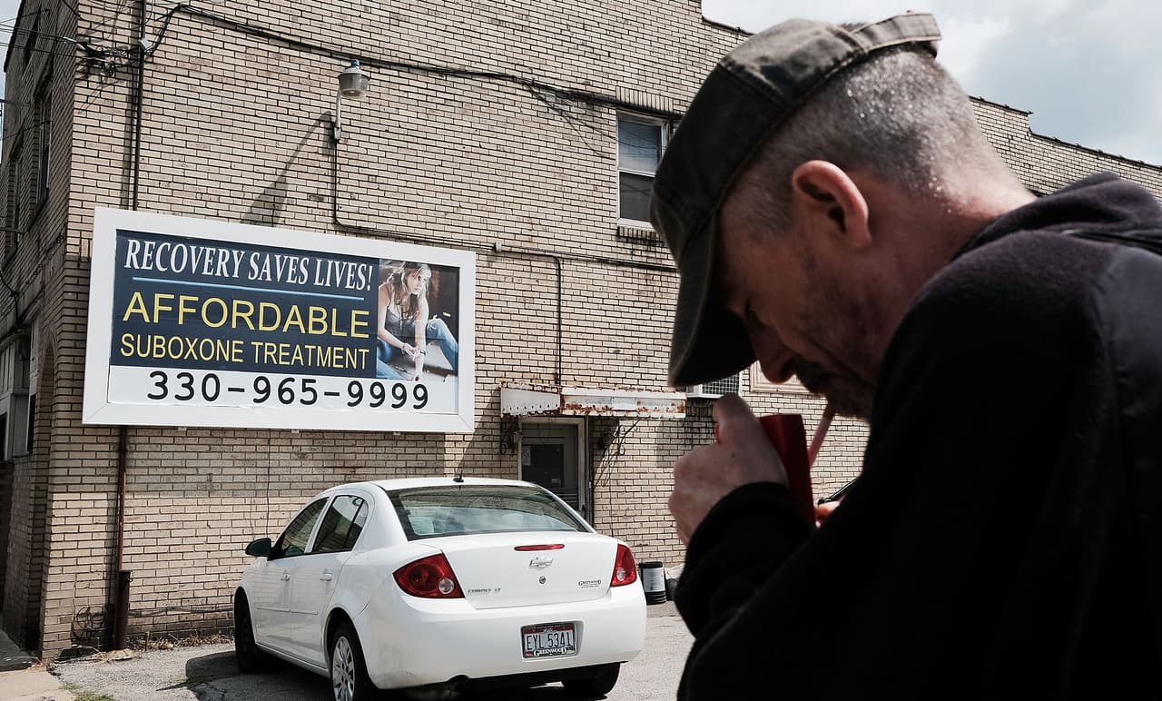 YOUNGSTOWN, OH - JULY 14: A man walks by a billboard for a drug recovery center in Youngstown on July 14, 2017 in Youngstown, Ohio. Youngstown, a city that was once one of the nation's manufacturing hubs, has been struggling with high unemployment and a surge in opioid addiction. (Photo by Spencer Platt/Getty Images)