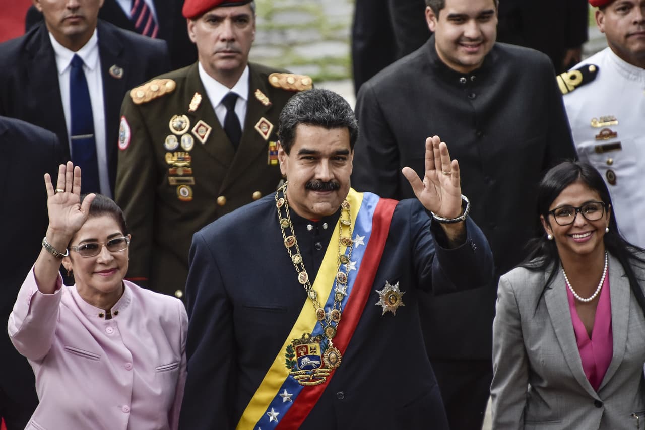 Nicolas Maduro, president of Venezuela, center, Cilia Flores, First Lady of Venezuela, left, and Delcy Rodriguez, president of the Constituent Assembly, wave while arriving to the National Assembly building in Caracas, Venezuela, on Thursday, Aug. 10, 2017. Venezuelan opposition parties, reeling after Maduro installed a legislative super-body that usurps the little power they had, will participate in gubernatorial elections this year, a choice they described as an act of defiance. Photographer: Carlos Becerra/Bloomberg via Getty Images