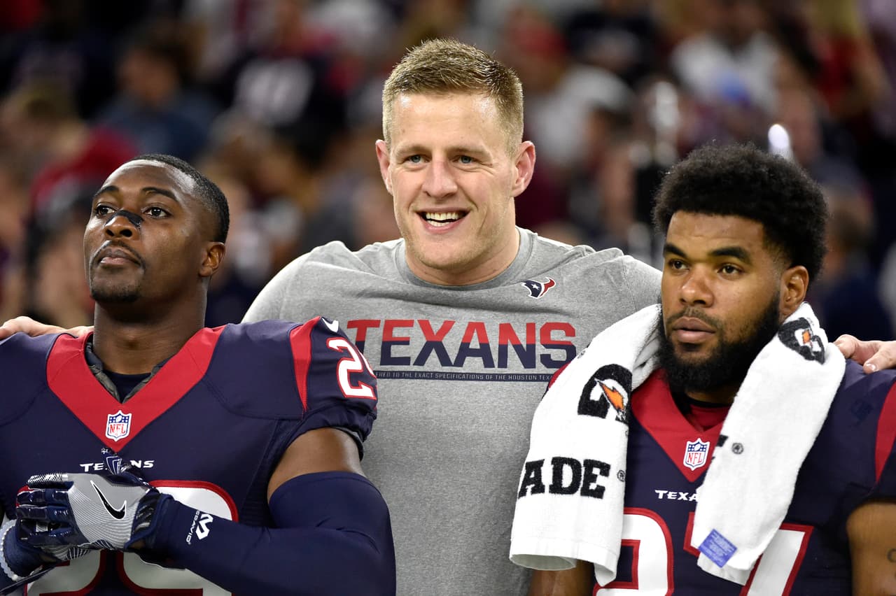 Houston Texans defensive end J.J. Watt, center, stands on the sidelines with teammates Andre Hal (29) and Quintin Demps (27) during the first half of an NFL football game against the Cincinnati Bengals Saturday, Dec. 24, 2016, in Houston. (AP Photo/Eric Christian Smith)