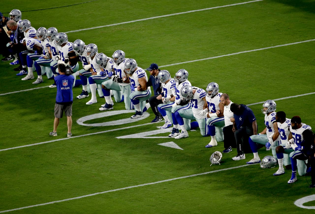 The Dallas Cowboys take a knee prior to the national anthem prior to an NFL football game against the Arizona Cardinals, Monday, Sept. 25, 2017, in Glendale, Ariz. (AP Photo/Matt York)