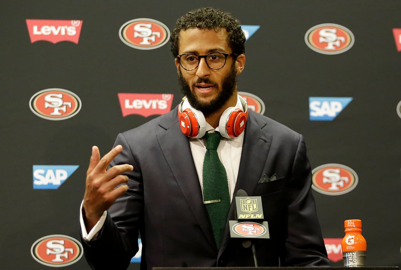 FILE - In this Oct. 18, 2015, file photo, San Francisco 49ers quarterback Colin Kaepernick speaks at a news conference after an NFL football game against the Baltimore Ravens in Santa Clara, Calif. The choice for the San Francisco 49ers might come down to paying Colin Kaepernick $11.9 million to wear their uniform in 2016 or $4.9 million to wear Denver's. (AP Photo/Marcio Jose Sanchez, File)