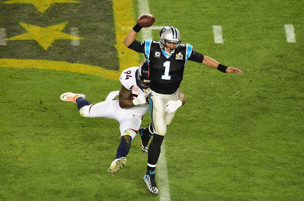 SANTA CLARA, CA - FEBRUARY 07: Quarterback Cam Newton #1 of the Carolina Panthers looks to pass and escape tackle from DeMarcus Ware #94 of the Denver Broncos during Super Bowl 50 at Levi's Stadium on February 7, 2016 in Santa Clara, California. (Photo by Harry How/Getty Images)