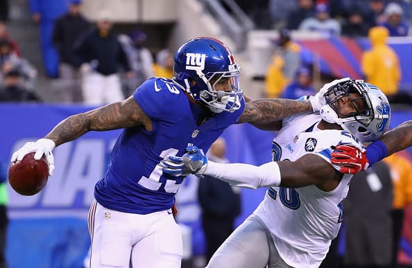EAST RUTHERFORD, NJ - DECEMBER 18: Odell Beckham #13 of the New York Giants carries the ball as he escapes a taclke from Don Carey #26 of the Detroit Lions in the second half at MetLife Stadium on December 18, 2016 in East Rutherford, New Jersey. (Photo by Al Bello/Getty Images)
