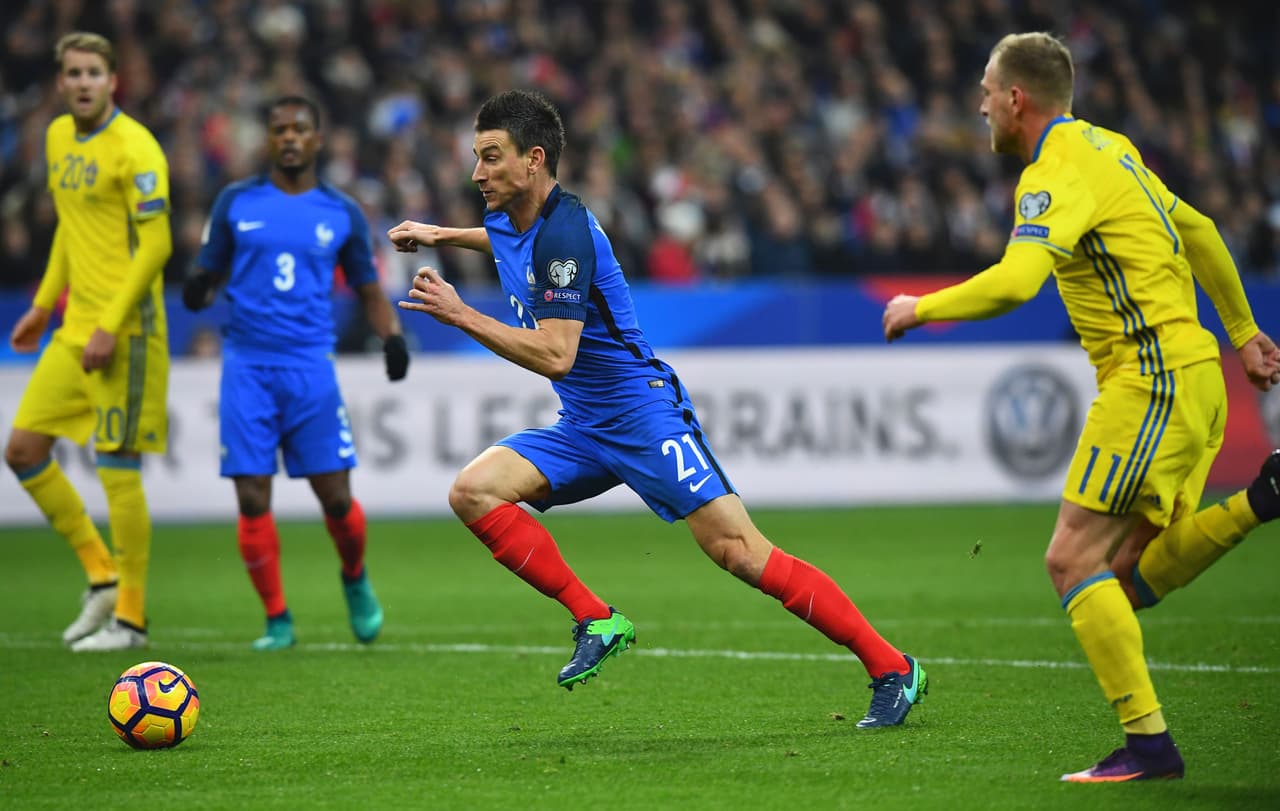 France's defender Laurent Koscielny advances with the ball past Sweden's forward John Guidetti during the 2018 World Cup group A qualifying football match between France and Sweden at the Stade de France in Saint-Denis, north of Paris, on November 11, 2016. / AFP / FRANCK FIFE (Photo credit should read FRANCK FIFE/AFP/Getty Images)