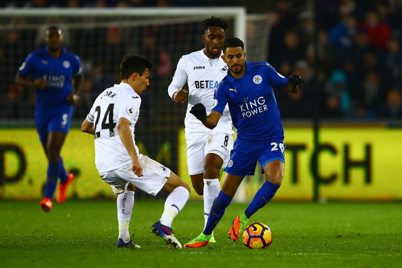 Swansea City's English midfielder Jack Cork (L) vies with Leicester City's Algerian midfielder Riyad Mahrez (R) during the English Premier League football match between Swansea City and Leicester City at The Liberty Stadium in Swansea, south Wales on February 12, 2017. / AFP / Geoff CADDICK / RESTRICTED TO EDITORIAL USE. No use with unauthorized audio, video, data, fixture lists, club/league logos or 'live' services. Online in-match use limited to 75 images, no video emulation. No use in betting, games or single club/league/player publications. / (Photo credit should read GEOFF CADDICK/AFP/Getty Images)