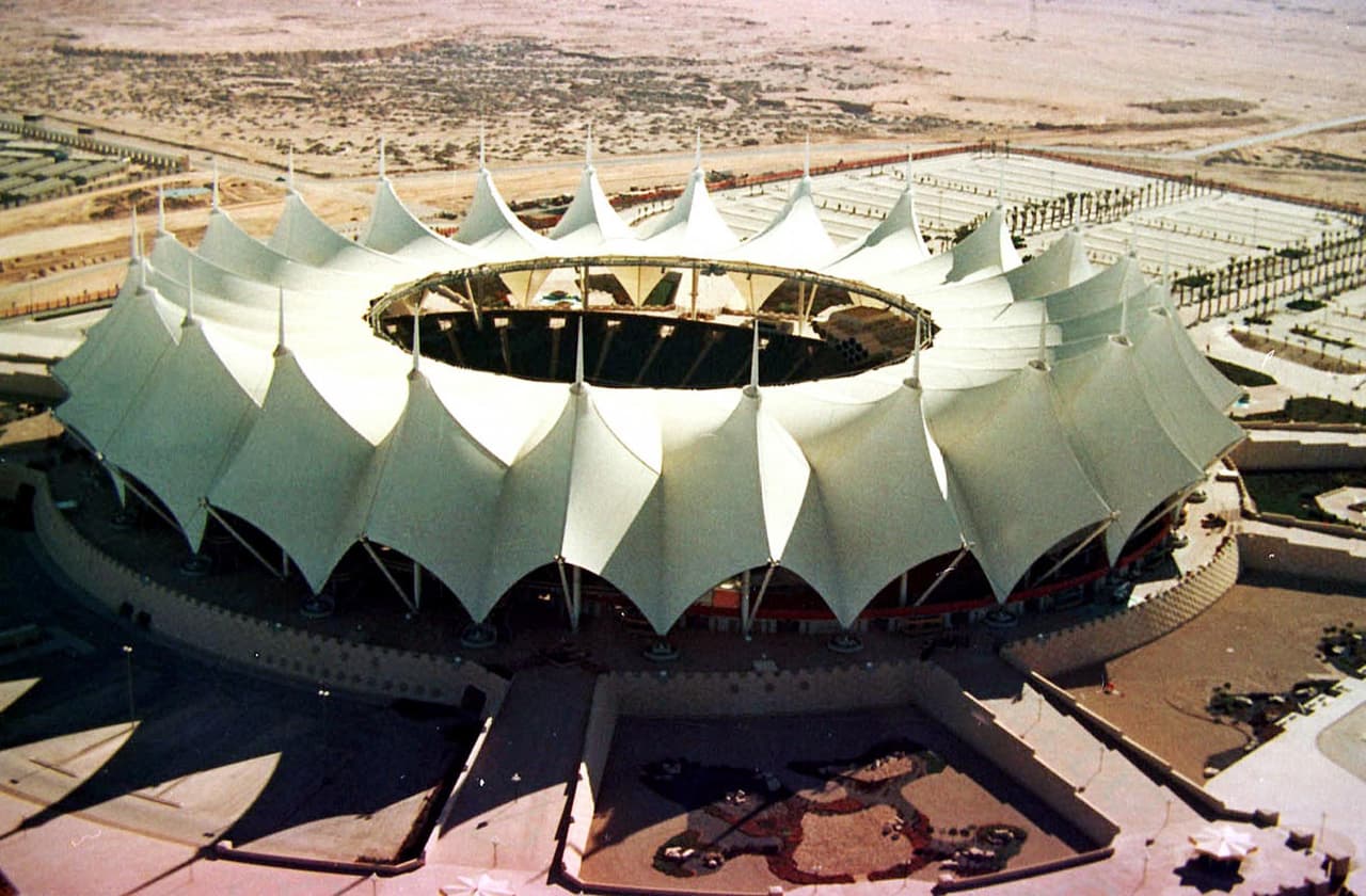 El estadio Rey Fahd está dedicado al rey saudí Fahd bin Abd Aziz. El escenario en el desierto de Arabia Saudita puede recibir 67 mil espectadores, que está bajo sombra gracias al techo que los cubre.