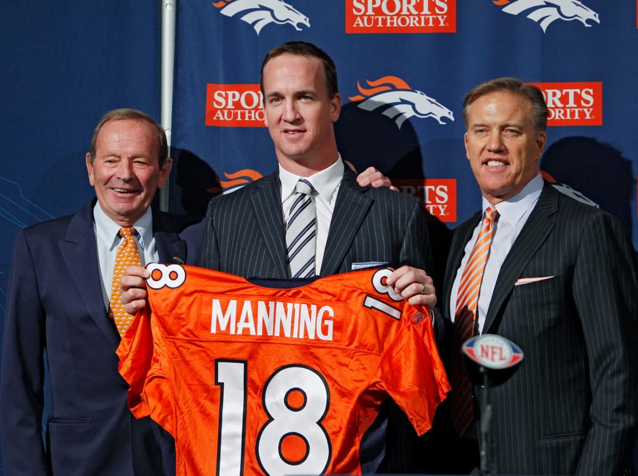 Peyton Manning, flanqueado por el dueño de los Broncos Pat Bowlin, y el vicepresidente del equipo John Elway, es presentado como integrante de Denver el 20 de marzo del 2012.