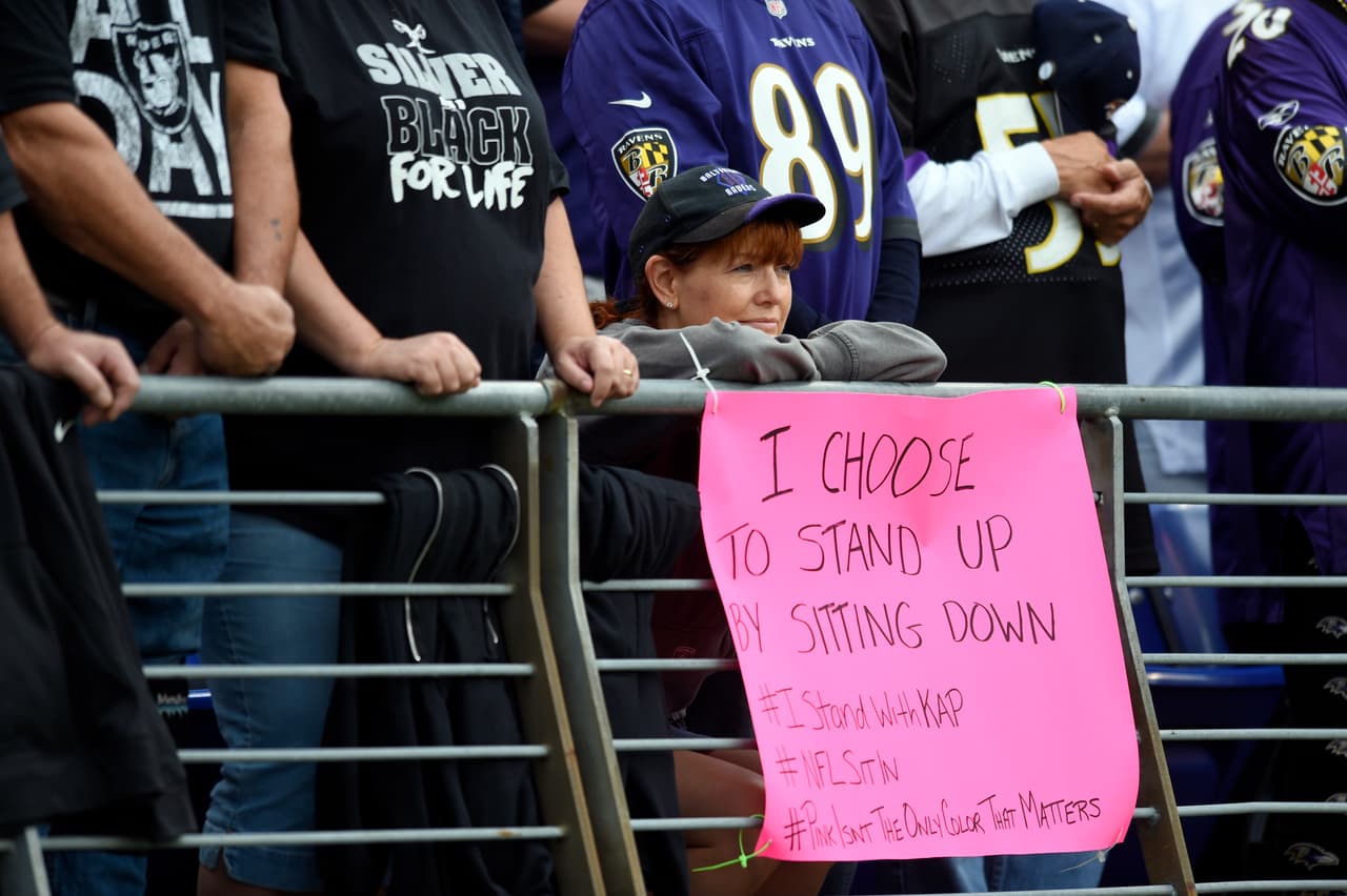 A Baltimore Ravens fan displays a sign in support of San Francisco 49ers quarterback Colin Kaepernick before an NFL football game between the Baltimore Ravens and the Oakland Raiders, Sunday, Oct. 2, 2016, in Baltimore. (AP Photo/Gail Burton)