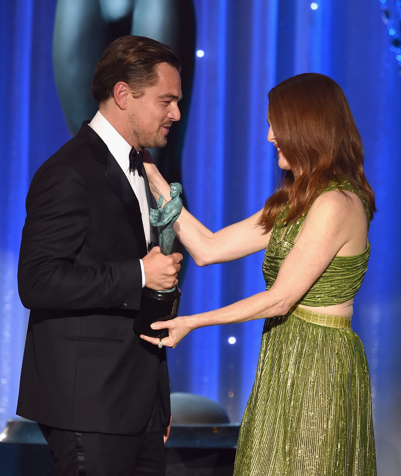 Julianne dándole su trofeo a Leonardo DiCaprio por 'The Revenant'.