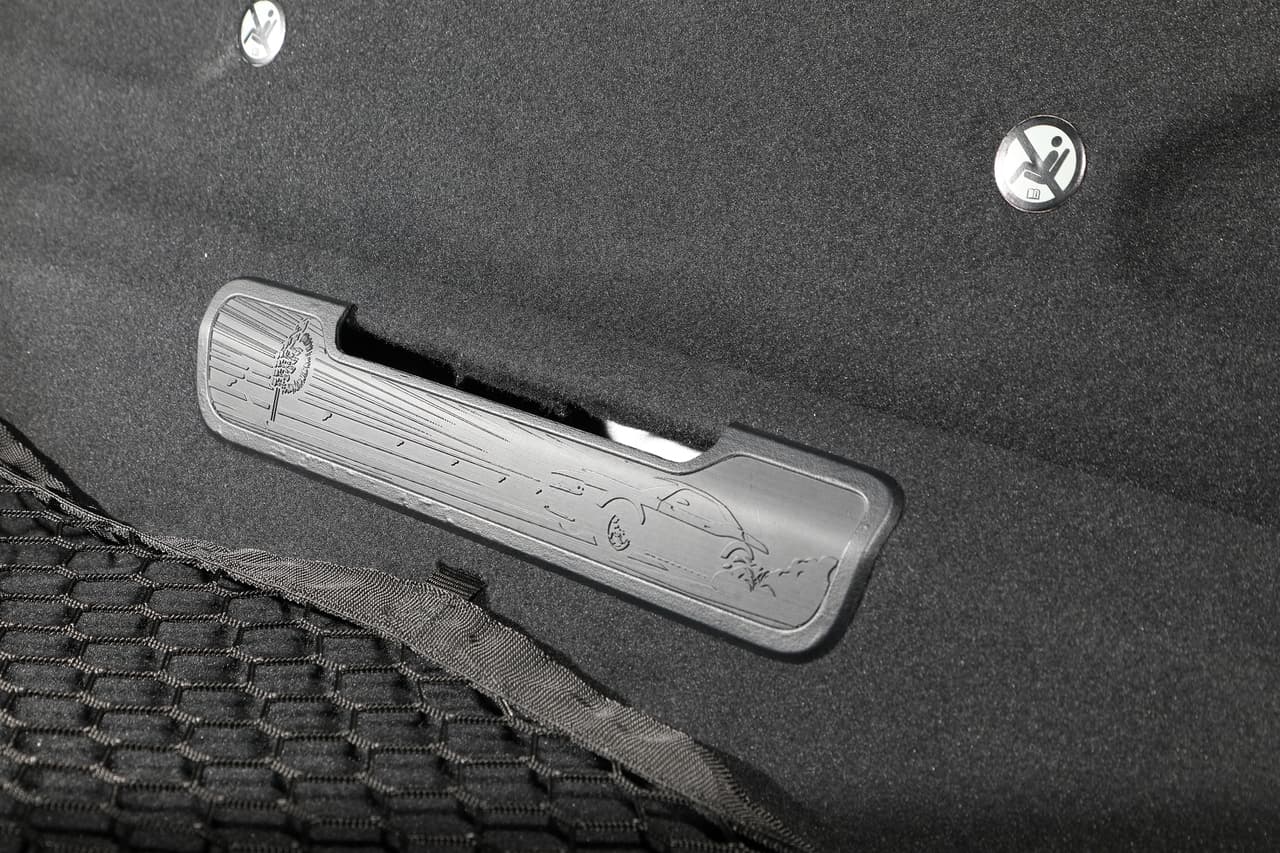 The 2018 Dodge Challenger SRT Demon’s rear-seat-delete access cover depicts a drag strip with SRT Demon burnout.