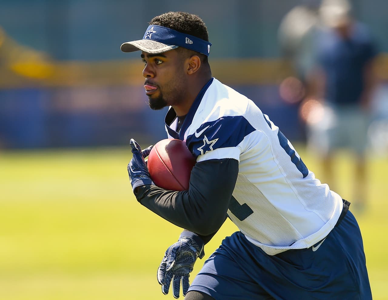 FILE - In this Aug. 2, 2016, file photo, Dallas Cowboys running back Ezekiel Elliott carries the ball during practice at the NFL football team's training camp in Oxnard, Calif. Elliott is among several first-round picks, not including quarterbacks, that are intriguing potential impact players for their new teams. (AP Photo/Gus Ruelas, File)