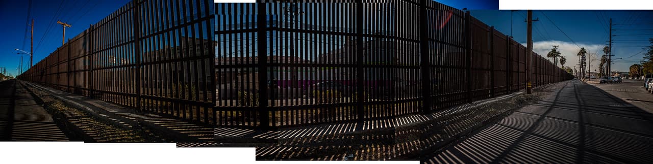 <b>High fence separate the cities of Mexicali, in Mexico, and Calexico, in the United States</b>. Mexicali and Calexico are sister cities separated by a high wall. In Mexicali there are about 160 maquiladoras, multi-national assembly export factories that have made the city a commercial hub. But the city has also been affected by smuggling and drug trafficking. Because it has become difficult to climb over the fence, cartels often resort to building clandestine tunnels - equipped with electric lighting and ventilation - that extend below the fence and reach well into Calexico.