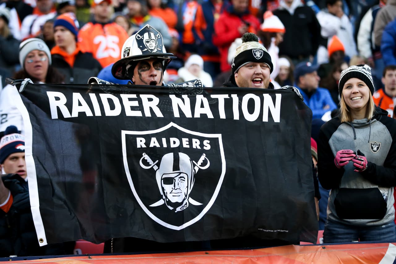 DENVER, CO - DECEMBER 13: Oakland Raiders fans cheer as their team leads the Denver Broncos at Sports Authority Field at Mile High on December 13, 2015 in Denver, Colorado. (Photo by Doug Pensinger/Getty Images)