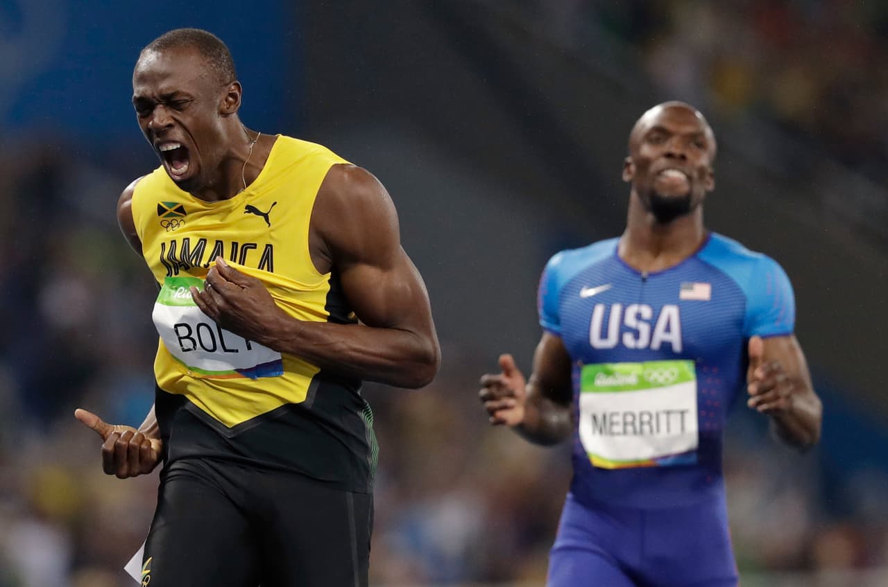 Usain Bolt from Jamaica, left, celebrates winning the gold medal in the men's 200-meter final during the athletics competitions of the 2016 Summer Olympics at the Olympic stadium in Rio de Janeiro, Brazil, Thursday, Aug. 18, 2016. (AP Photo/David J. Phillip)