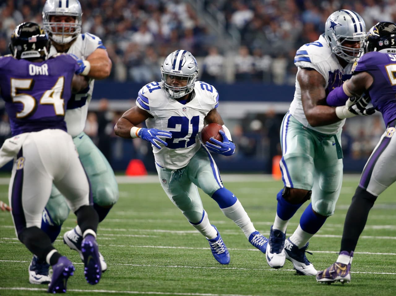 Baltimore Ravens' Zach Orr (54) and Terrell Suggs, right, rush as Dallas Cowboys' Ezekiel Elliott (21) finds running room through the line of scrimmage in the second half of an NFL football game, Sunday, Nov. 20, 2016, in Arlington, Texas. (AP Photo/Michael Ainsworth)