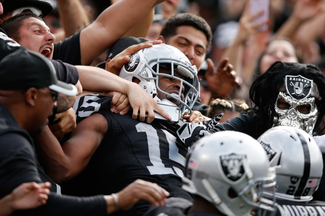 OAKLAND, CA - NOVEMBER 01: Michael Crabtree #15 of the Oakland Raiders celebrates with fans after a 36-yard touchdown against the New York Jets during their NFL game at O.co Coliseum on November 1, 2015 in Oakland, California. (Photo by Ezra Shaw/Getty Images)
