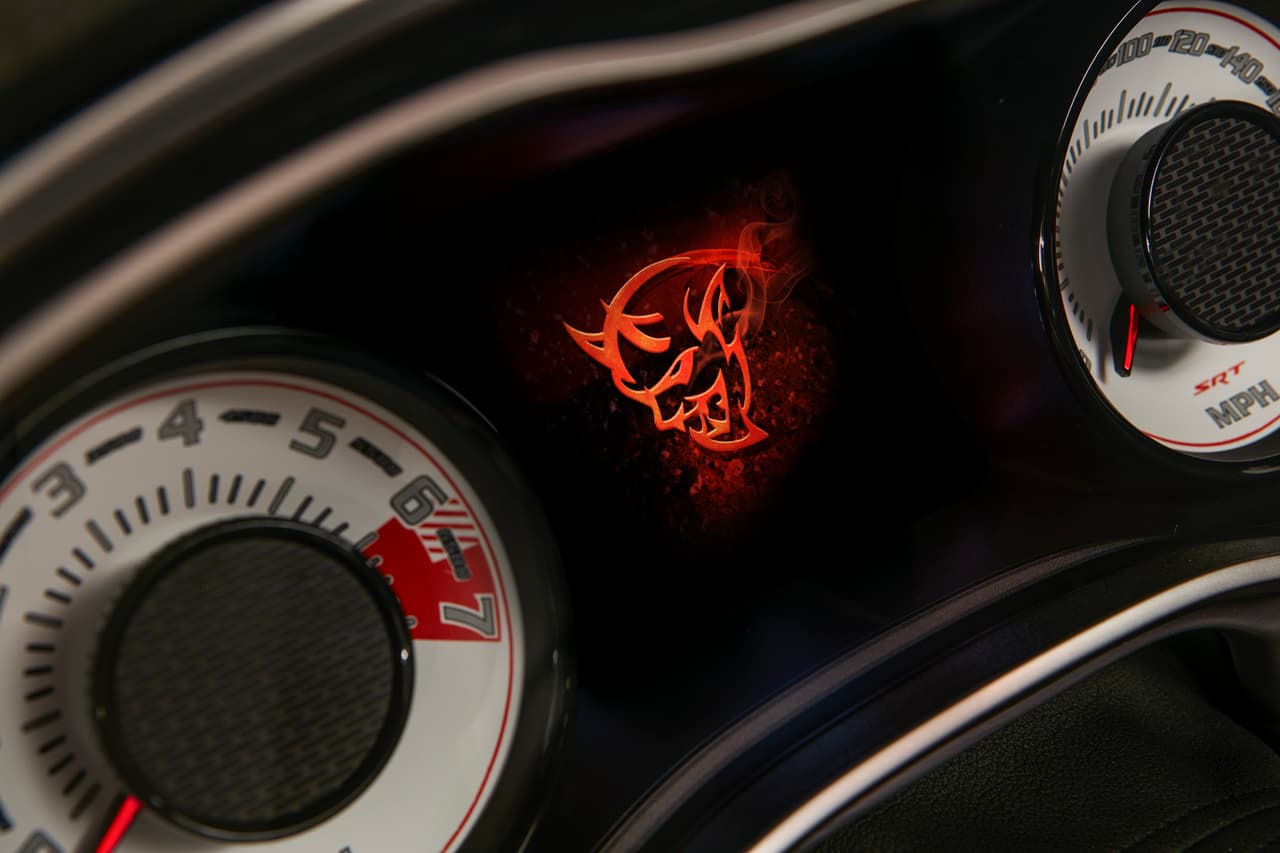 The Demon logo startup screen displayed on the 2018 Dodge Challenger SRT Demon’s 7-inch instrument cluster screen centered between the exclusive SRT Demon white face gauges.
