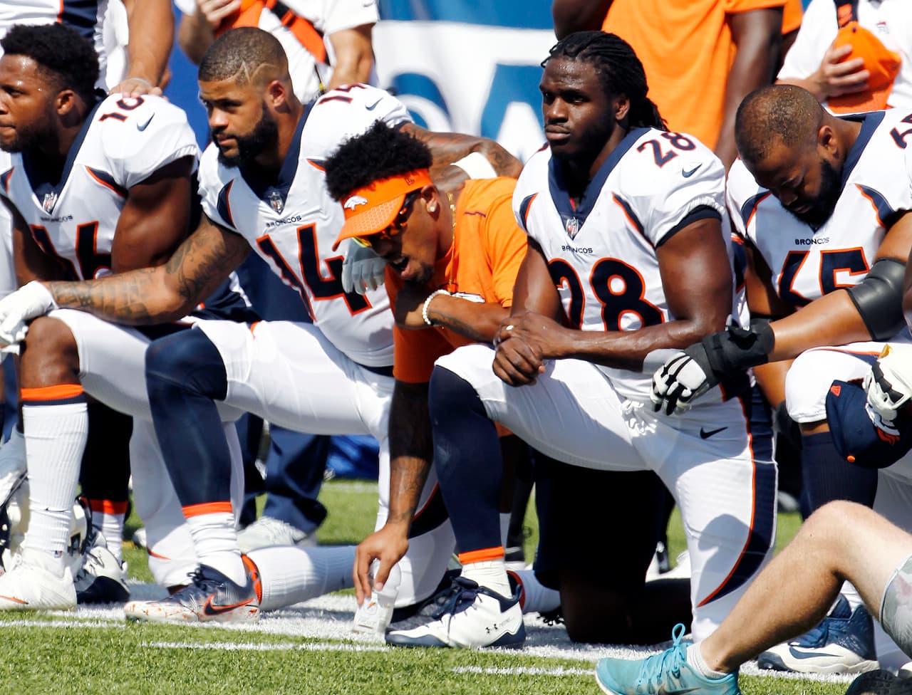 Denver Broncos players, including Jamaal Charles (28) kneel during the national anthem prior to an NFL football game against the Buffalo Bills, Sunday, Sept. 24, 2017, in Orchard Park, N.Y. (AP Photo/Jeffrey T. Barnes)