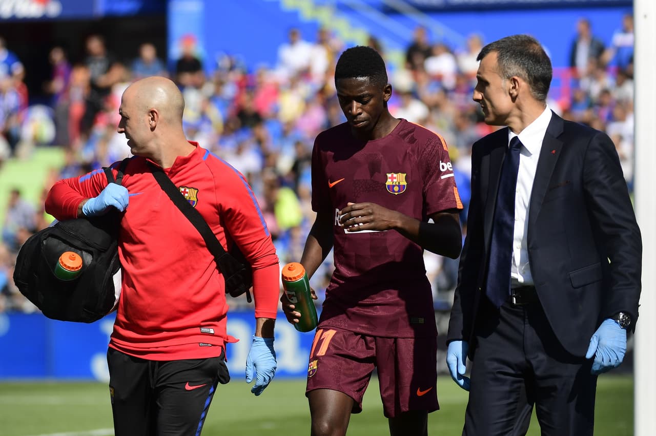 Barcelona's forward from France Ousmane Dembele (C) walks with the team's doctor during the Spanish league football match Getafe CF vs FC Barcelona at the Col. Alfonso Perez stadium in Getafe on September 16, 2017. / AFP PHOTO / PIERRE-PHILIPPE MARCOU (Photo credit should read PIERRE-PHILIPPE MARCOU/AFP/Getty Images)