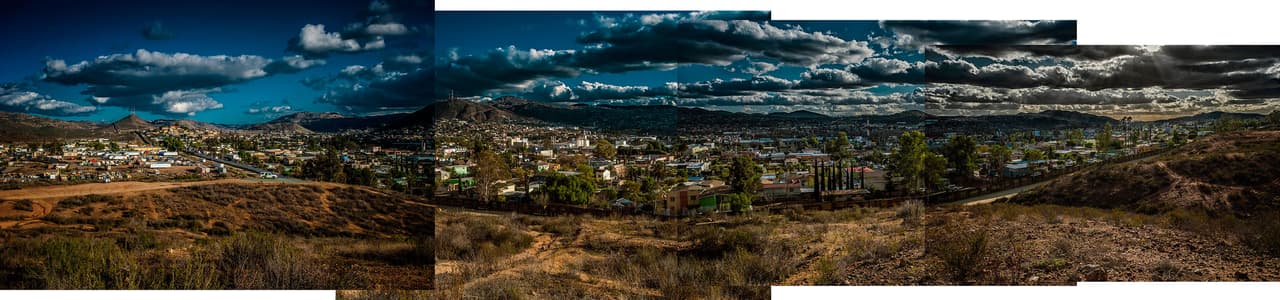 <b>Section of the wall separating the city of Tecate, Mexico, from the territory of the United States</b>. Usually, cities on the Mexican side of the border go right up to the fence, while on the other side there is plenty of open countryside. That's the case in Tecate, a city famous for its beer of the same name. In 2012 it received the tourist label "Pueblo Magico," for its beautiful landscapes and the warmth of its people. Although Tecate is a relatively safe border town, mountains both to the east and west along the border can be risky for migrants. The U.S. Border Patrol, as seen in the photo, maintains full-time surveillance of the area.