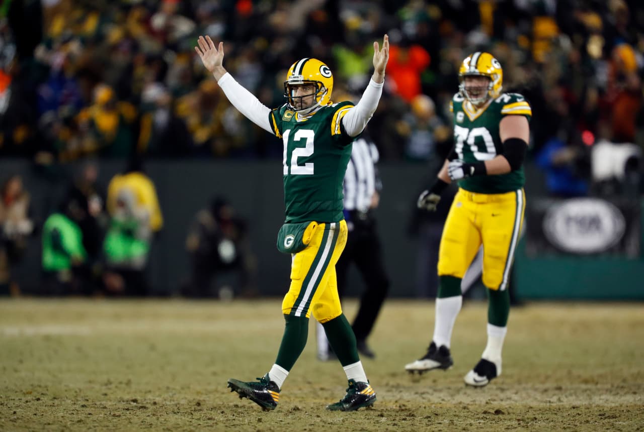 Green Bay Packers quarterback Aaron Rodgers (12) celebrates after throwing a touchdown pass to wide receiver Randall Cobb during the first half of an NFC wild-card NFL football game, Sunday, Jan. 8, 2017, in Green Bay, Wis. (AP Photo/Matt Ludtke)