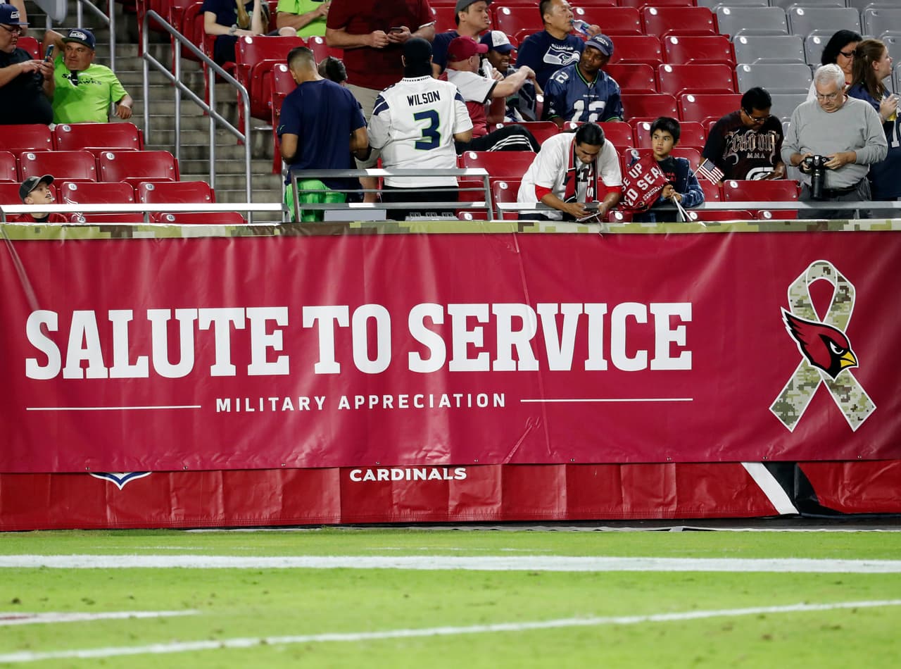 An NFL Salute to Service sign is seen prior to an NFL football game between the Seattle Seahawks and the Arizona Cardinals, Thursday, Nov. 9, 2017, in Glendale, Ariz. (AP Photo/Rick Scuteri)