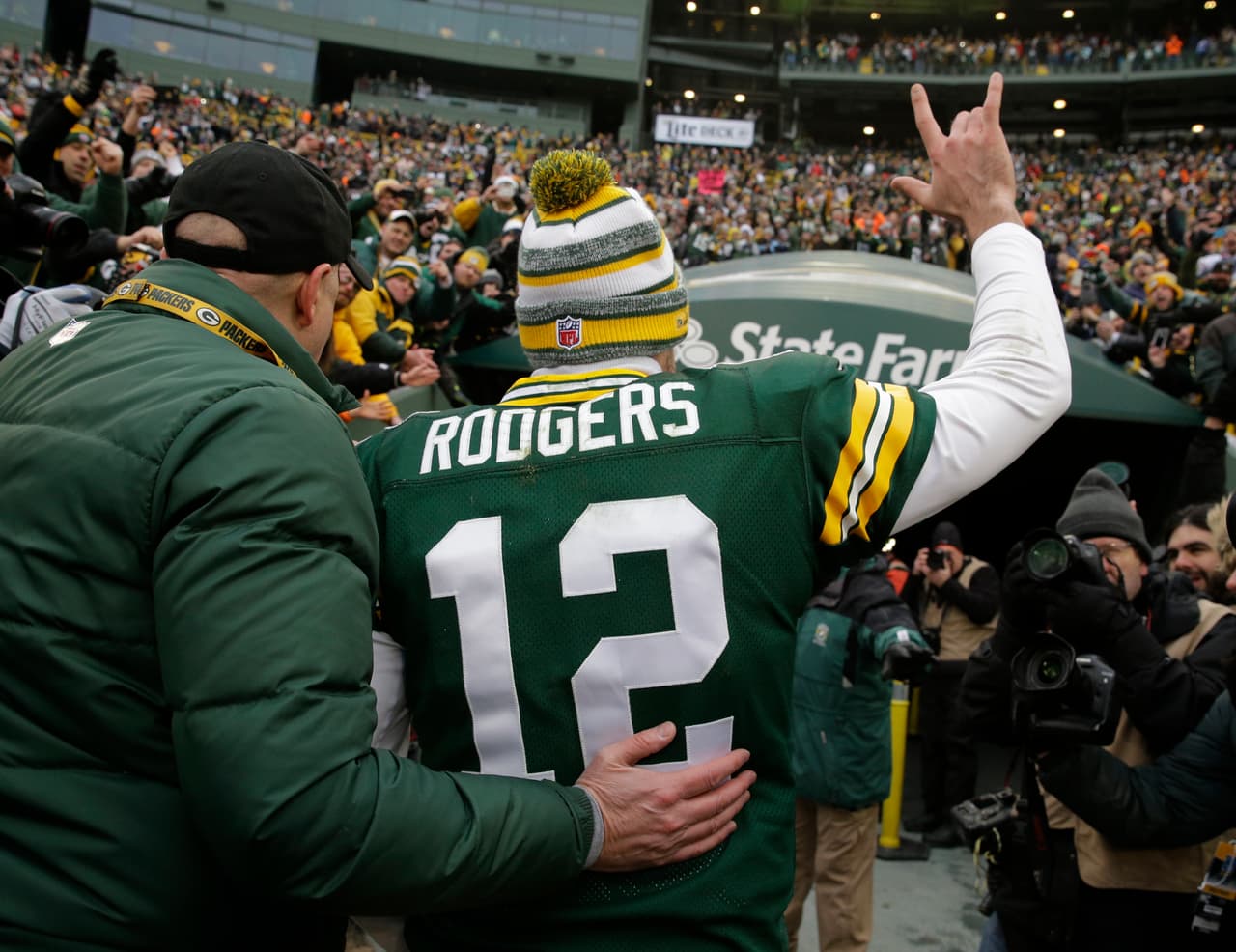 Green Bay Packers quarterback Aaron Rodgers waves to fans after an NFL divisional playoff football game against the Dallas Cowboys Sunday, Jan. 11, 2015, in Green Bay, Wis. The Packers won 26-21. (AP Photo/Nam Y. Huh)