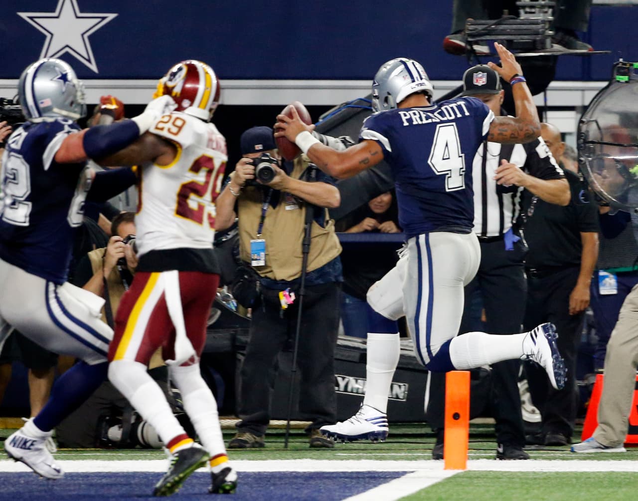 Dallas Cowboys quarterback Dak Prescott (4) scores on a run as tight end Jason Witten (82) helps against pressure from Washington Redskins strong safety Duke Ihenacho (29) in the second half of an NFL football game, Thursday, Nov. 24, 2016, in Arlington, Texas. (AP Photo/Michael Ainsworth)