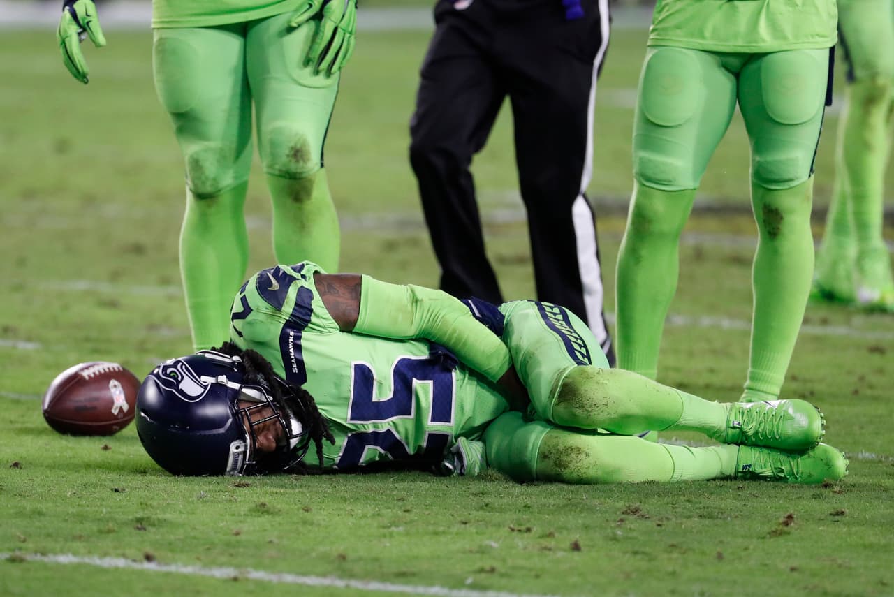 Seattle Seahawks cornerback Richard Sherman (25) lies on the turf after tackling Arizona Cardinals wide receiver John Brown during the second half of an NFL football game, Thursday, Nov. 9, 2017, in Glendale, Ariz. (AP Photo/Rick Scuteri)