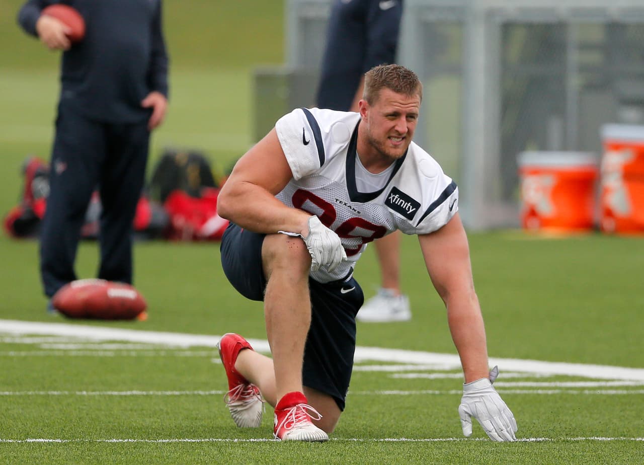 Houston Texans defensive end J.J. Watt stretches at the start of a morning practice at the Dallas Cowboys training facility, Monday, Aug. 28, 2017, in Frisco, Texas. The Texans are working out in the practice facility of the Dallas Cowboys because of floods pounding Houston. An exhibition game in the Texans' stadium Thursday might be moved to the home of the Cowboys. (AP Photo/Tony Gutierrez)
