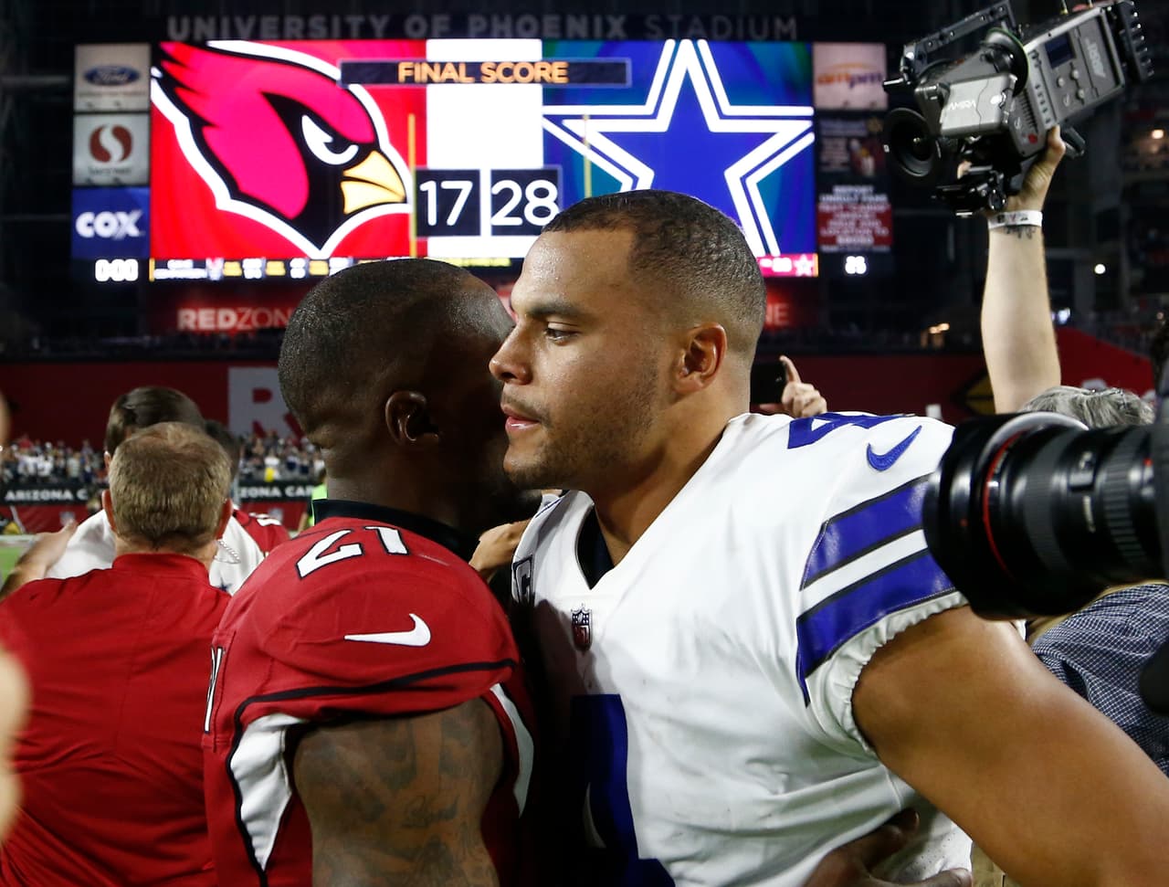 Dallas Cowboys quarterback Dak Prescott (4) and Arizona Cardinals cornerback Patrick Peterson (21) meet after an NFL football game, Monday, Sept. 25, 2017, in Glendale, Ariz. The Cowboys won 28-17. (AP Photo/Ross D. Franklin)