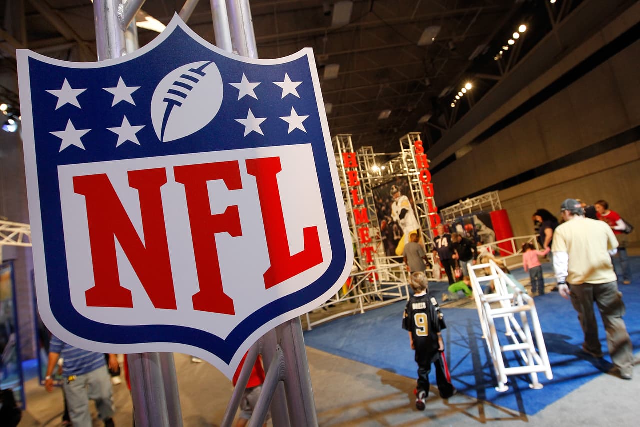 DALLAS, TX - JANUARY 29: Football fans make their way through the NFL Experience exhibit at the Dallas Convention Center on January 29, 2011 in Dallas, Texas. The 850,000 square foot NFL theme park is open to fans leading up to Super Bowl XLV. (Photo by Tom Pennington/Getty Images)