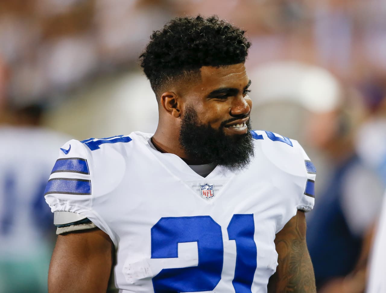 Dallas Cowboys running back Ezekiel Elliott (21) smiles on the sideling during the first half of the Pro Football Hall of Fame NFL preseason game against the Arizona Cardinals in Canton, Ohio, Thursday, Aug. 3, 2017. (AP Photo/Ron Schwane)