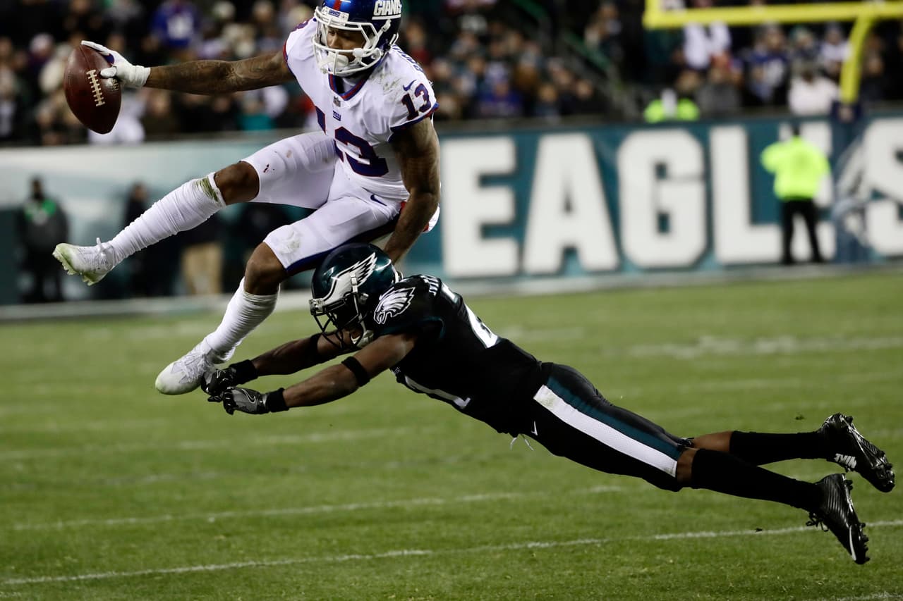 New York Giants' Odell Beckham (13) is hit by Philadelphia Eagles' Leodis McKelvin (21) during the second half of an NFL football game, Thursday, Dec. 22, 2016, in Philadelphia. (AP Photo/Michael Perez)
