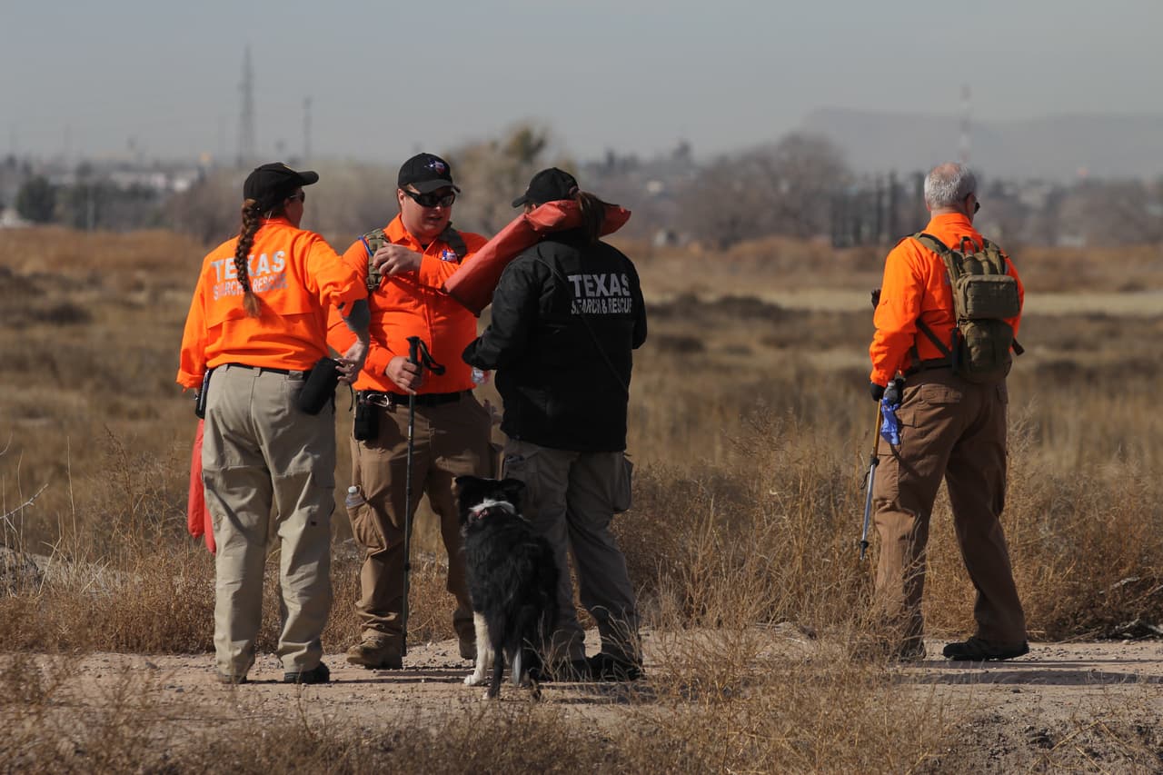 Miembros del equipo de búsqueda y rescate de Texas acompañados por perros y policías mexicanos escanean un canal en busca de un niño estadounidense desaparecido.