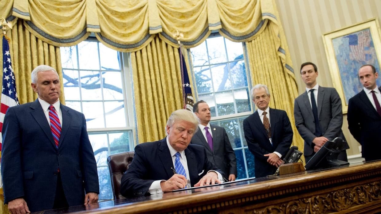 Stephen Miller, far right, in the Oval Office as Trump signs an executive order.