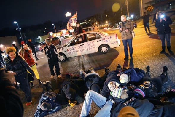 Algunos manifestantes se recostaron en el piso para bloquear la intersección de una de las calles.