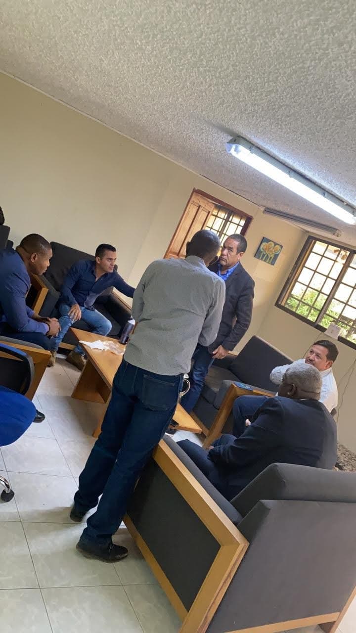 A security meeting of CTU Security in Haiti. From left to right: James Solages (seated), former Captain Germán Rivera, Antonio Intriago (standing) former Sergeant Duberney Capador (seated) Christian Sanon (seated). The man standing with his back to the camera could not be identified.