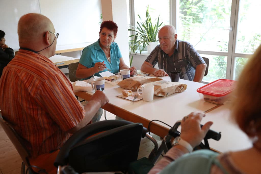 BERLIN, GERMANY - AUGUST 24: Pensioners, who said they did not mind being photographed, chat over coffee and cake in the commons room at a food distribution point organized by the Berliner Tafel at the Protestant Church Community Center Lichtenrade on August 24, 2017 in Berlin, Germany. Approximately 300 households rely on the weekly opportunity to pay a symbolic amount for expired groceries donated by local supermarkets and bakeries. Among the needy are Germans, especially pensioners whose pensions are insufficient, as well as migrants, including refugees who arrived since 2015 but also ethnic Germans from the former Soviet Union who came to Germany after 1989. Germany faces federal elections on September 24 and poverty, which has remained stubbornly persistent despite the country's strong economy, is a major election topic. (Photo by Sean Gallup/Getty Images)