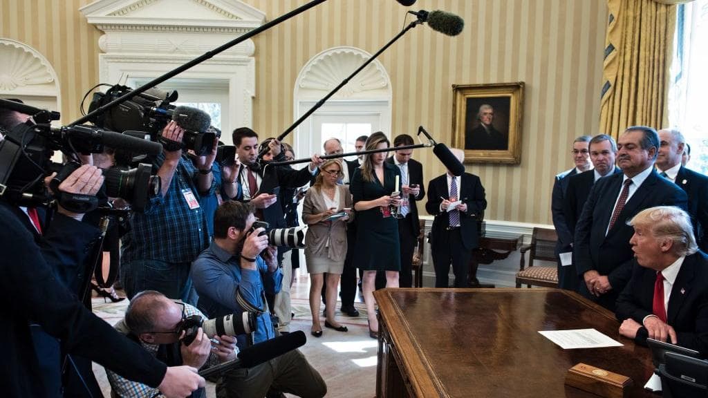 President Donald Trump speaks to the press in the Oval Office.