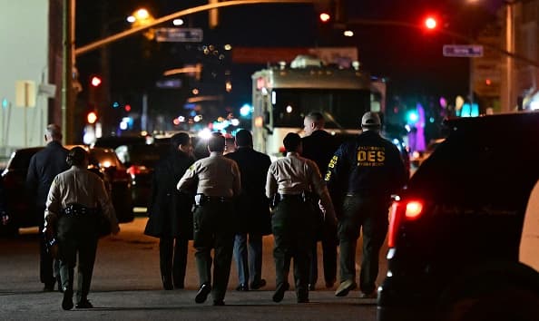 Investigators from the Los Angeles County Sheriff's Department Homicide bureau walk away after briefing the media in Monterey Park, California on January 22, 2023. - Ten people have died and at least 10 others been wounded in a mass shooting in a largely Asian city in southern California, law enforcement said January 22, with the suspect still at large hours later. (Photo by Frederic J. BROWN / AFP) (Photo by FREDERIC J. BROWN/AFP via Getty Images)