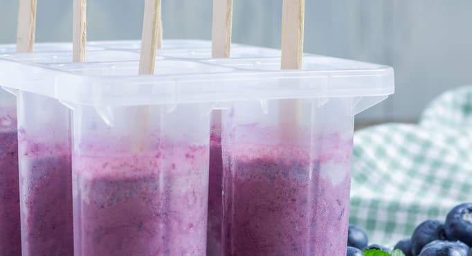 Homemade popsicles with blueberry yogurt and honey