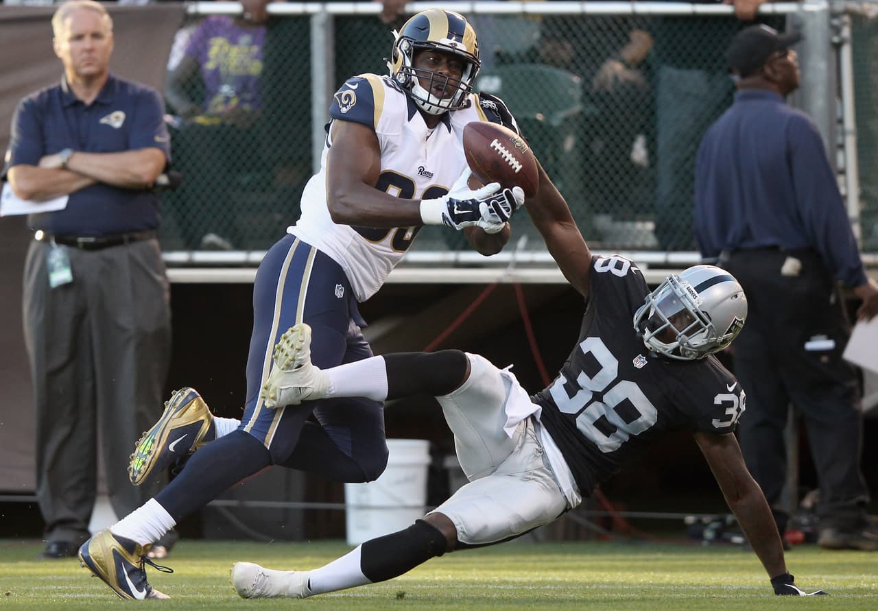 OAKLAND, CA - AUGUST 14: TJ Carrie #38 of the Oakland Raiders breaks up a pass intended for Jared Cook #89 of the St. Louis Rams at O.co Coliseum on August 14, 2015 in Oakland, California. (Photo by Ezra Shaw/Getty Images)