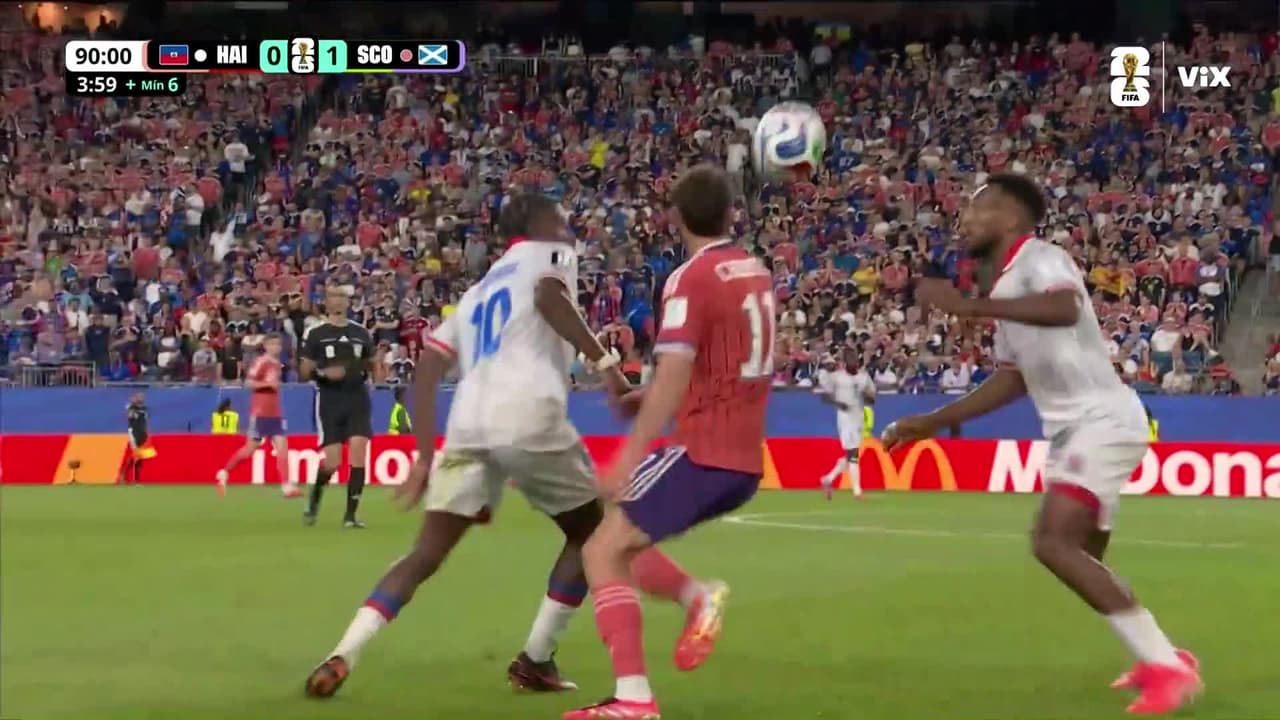 ¿Era de roja? Kenny McLean se olvida del esférico y le deja recuerdo a haitiano.