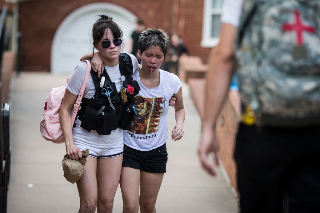 A woman is affected by tear gas from law enforcement officials.