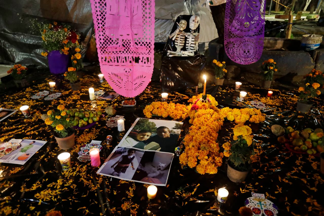 Un altar conmemora el Día de los Muertos en un campamento frente al edificio Tlalpan, que colapsó con el terremoto del 19 de septiembre en Ciudad de México. Las fotografías de Julián Flores, de 11 años, y su hermanita Ximena, de seis, fueron colocadas en el altar por su madre Nayeli Flores. En ese lugar fallecieron nueve personas.