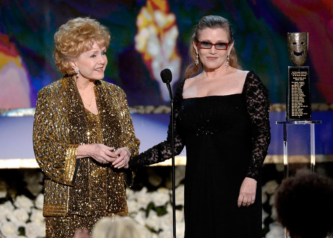 LOS ANGELES, CA - JANUARY 25: Actress Debbie Reynolds (L) accepts the Life Achievement Award from actress Carrie Fisher onstage at the 21st Annual Screen Actors Guild Awards at The Shrine Auditorium on January 25, 2015 in Los Angeles, California. (Photo by Kevork Djansezian/Getty Images)