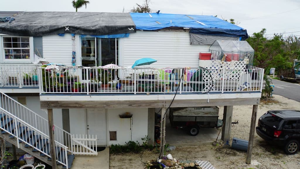 Tarps cover a house with the roof still unrepaired after the damage caused by hurricane Irma in Big Pine Key, Florida on May 29th, 2018.