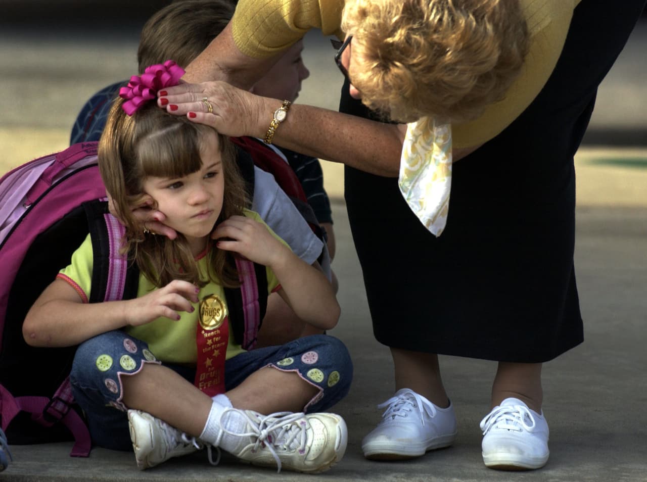 Patterson Elementary School teacher's aide Sue Price, right, examines Ashlyn Blocker's head for scrapes, Tuesday, Oct. 26, 2004, after she bumped it after school. If she's scratched or cut, Ashlyn never complains because of her rare disease. The 5-year-old is among a small number of people in the world known to have congenital insensitivity to pain with anhidrosis, or CIPA - a rare genetic disorder that makes her unable to feel pain. (AP Photo/Stephen Morton)