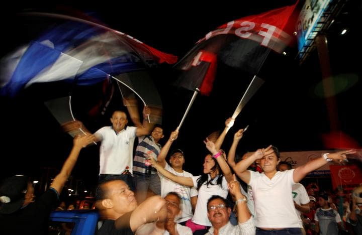 Supporters of Nicaragua's President Daniel Ortega and vice presidential candidate, his wife, Rosario Murillo wave a Nicaraguan flag and flags of the Sandinista National Liberation Front, or FSLN, while celebrating after preliminary results showed Ortega was on course for reelection, in Managua, Nicaragua November 6, 2016.
